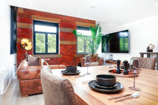 Interior of loft apartment with a red brick wall Interior design of loft apartment